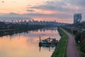 Beggining the night in metropolis and maintenance boat. Sao Paulo city highway beside the river, bicycle lane. Skyline