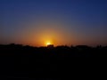 Sunset behind the buildings filled with organe and blue colur