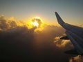 sunset behind clouds from airplane Royalty Free Stock Photo