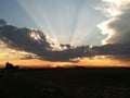 Sunset behind clouds over mountains Royalty Free Stock Photo