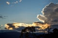 Sunset behind dense cumulus clouds