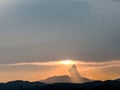 the sunset behind the mountain, the sky and the beautiful clouds shine