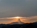 the sunset behind the mountain, the sky and the beautiful clouds shine