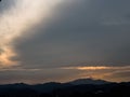 the sunset behind the mountain, the sky and the beautiful clouds shine