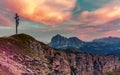 Sunset behind a mountain top cross in the Dolomites Royalty Free Stock Photo