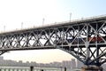 Sunset behind Nanjing Yangtze River Bridge with a train passing through the bridge