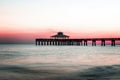 Sunset behind the pier of Fort Myers Beach, Florida Royalty Free Stock Photo