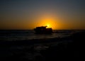 Sunset behind shipwreck near cape agulhas
