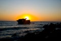 Sunset behind shipwreck near cape agulhas