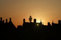 Sunset behind silhouetted roofs, London, England