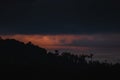 Sunset behind silhouettes of trees on the mountain Royalty Free Stock Photo