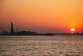 Sunset behind the Statue of Liberty Royalty Free Stock Photo