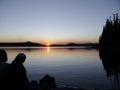 Sunset behind the tree at Waldo Lake is a natural alpine lake in the Cascade Mountains of the U.S. state of Oregon Royalty Free Stock Photo