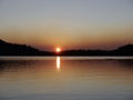 Sunset behind the tree at Waldo Lake is a natural alpine lake in the Cascade Mountains of the U.S. state of Oregon