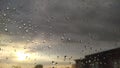 Sunset behind windowglass with raindrops. Royalty Free Stock Photo