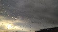 Sunset behind windowglass with raindrops. Royalty Free Stock Photo