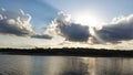 Sunset behing clouds over a lake