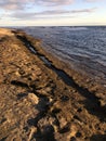 Sunset at Black and White Sand Beach with Reef in Winter in Kekaha on Kauai Island, Hawaii - Niihau Island in Horizon. Royalty Free Stock Photo