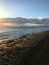 Sunset at Black and White Sand Beach with Reef in Winter in Kekaha on Kauai Island, Hawaii - Niihau Island in Horizon. Royalty Free Stock Photo