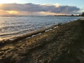Sunset at Black and White Sand Beach with Reef in Winter in Kekaha on Kauai Island, Hawaii - Niihau Island in Horizon. Royalty Free Stock Photo