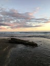 Sunset at Black and White Sand Beach with Reef in Winter in Kekaha on Kauai Island, Hawaii - Niihau Island in Horizon. Royalty Free Stock Photo