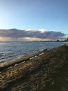 Sunset at Black and White Sand Beach with Reef in Winter in Kekaha on Kauai Island, Hawaii - Niihau Island in Horizon. Royalty Free Stock Photo