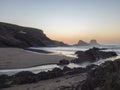 After sunset blue hour long exposure view of sand beach Praia da Zambujeira do Mar with rock and cliff, small stream and