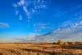 Sunset blue sky with delicate and fluffy clouds and a golden field Royalty Free Stock Photo