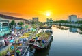 Sunset boat dock flower market along canal wharf.