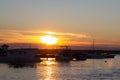 Sunset at the boat pier. Dark silhouettes of boats against the background of the setting sun on the water Royalty Free Stock Photo