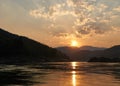 Sunset at boat ride on Mekong river in Laos. Tour with a ferry on Mekong river in Luang Prabang region. Amazing cliffs Royalty Free Stock Photo