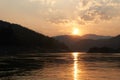 Sunset at boat ride on Mekong river in Laos. Tour with a ferry on Mekong river in Luang Prabang region. Amazing cliffs Royalty Free Stock Photo