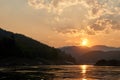 Sunset at boat ride on Mekong river in Laos. Tour with a ferry on Mekong river in Luang Prabang region. Amazing cliffs Royalty Free Stock Photo