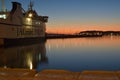 Sunset with boat waiting to leave the port