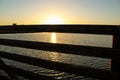 Sunset at bolsa chica wetlands through a wooden bridge