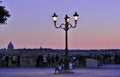 A sunset at Borghese Ville in Rome being contemplated by people