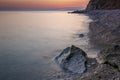 After Sunset, Boulders in the Calm Sea Royalty Free Stock Photo