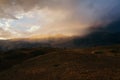 Sunset, bright sunlight in a dusty cloud, travel on the mountain valley, a landscape Royalty Free Stock Photo