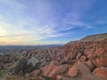 The sunset brightens the red and rose limestone rocks in the Red Valley of Cappadocia, Turkey