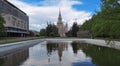 Sunset campus of Moscow university under cloudy sky with water reflections