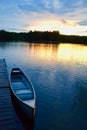 A sunset, a canoe, and a tranquil lake Royalty Free Stock Photo