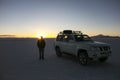 Sunset and car in Uyuni salar in Cordillera Real, Andes, Bolivia Royalty Free Stock Photo