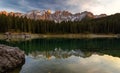 Sunset at Carezza lake with beautiful reflections of dolomites mountains Royalty Free Stock Photo
