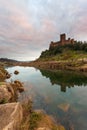Sunset at Castle Almourol, river Tagus in Portugal. Amazing landscape at sunset with the castle walls under red cloud sky. Beautif Royalty Free Stock Photo