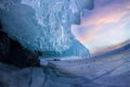 Sunset in a cave grotto with icicles in the winter on Olkhon Island, Lake Baikal Royalty Free Stock Photo