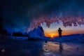 Sunset in a cave grotto with icicles in the winter on Olkhon Island, Lake Baikal Royalty Free Stock Photo