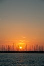 Sunset in Cecina Italy over the sea behind stone breakwater Royalty Free Stock Photo