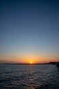 Sunset in Cecina Italy over the sea behind stone breakwater Royalty Free Stock Photo