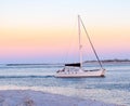 Sunset charter sail at Ponce Inlet jetty with New Smyrna Beach in the background Royalty Free Stock Photo