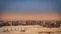 Sunset city landscape Giza Cairo with plateau pyramids Royalty Free Stock Photo